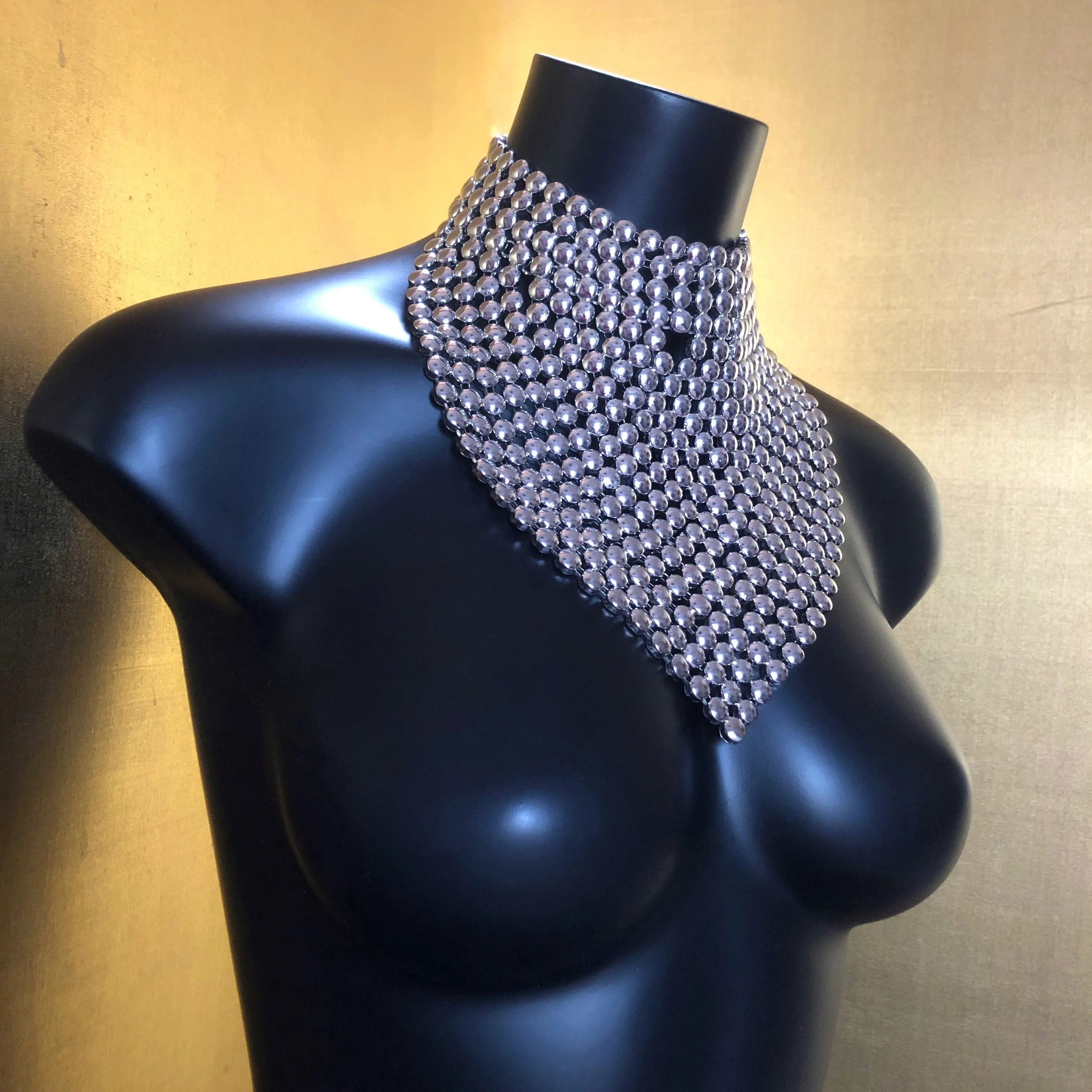 A CHROME GLADIATOR STYLE NECKPIECE