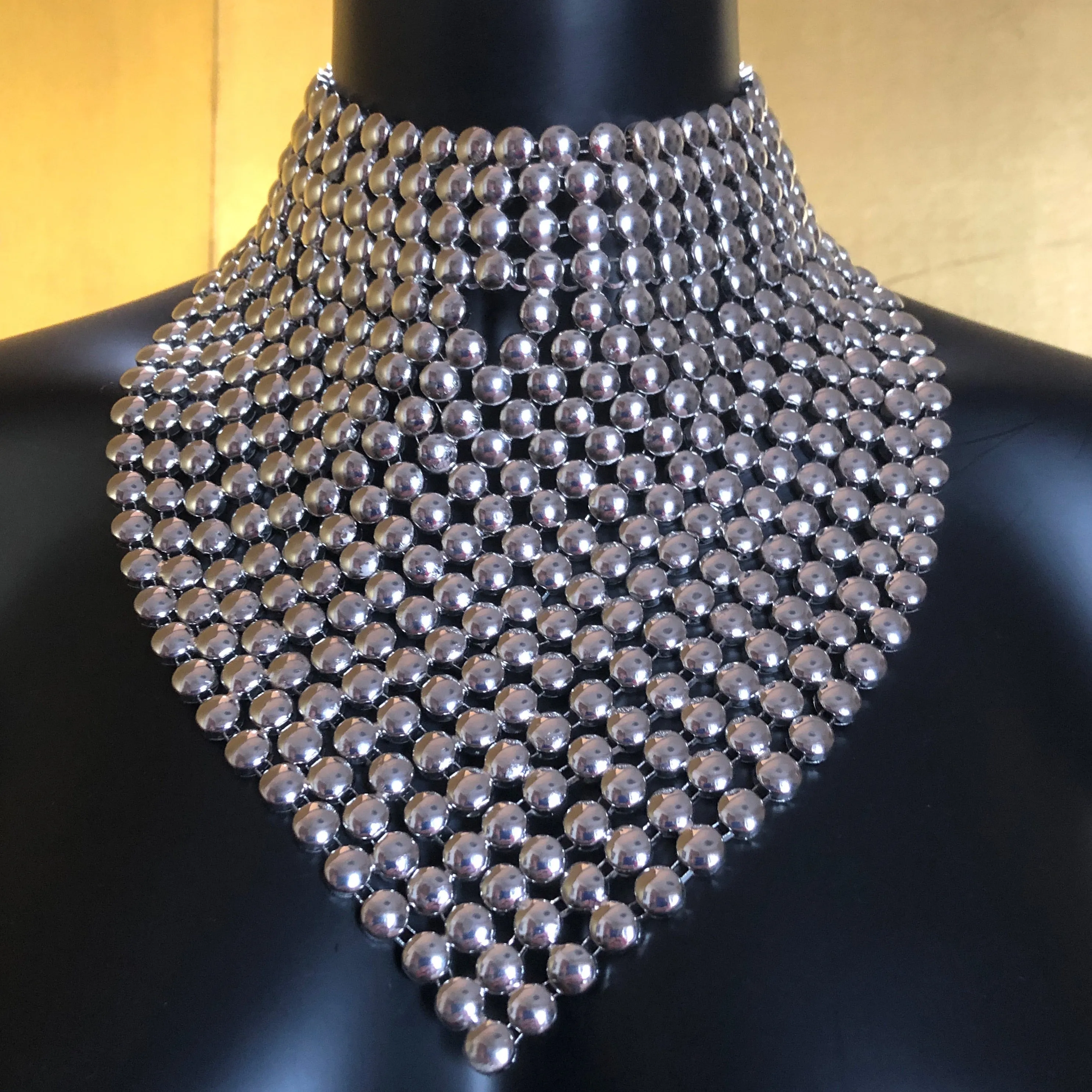 A CHROME GLADIATOR STYLE NECKPIECE