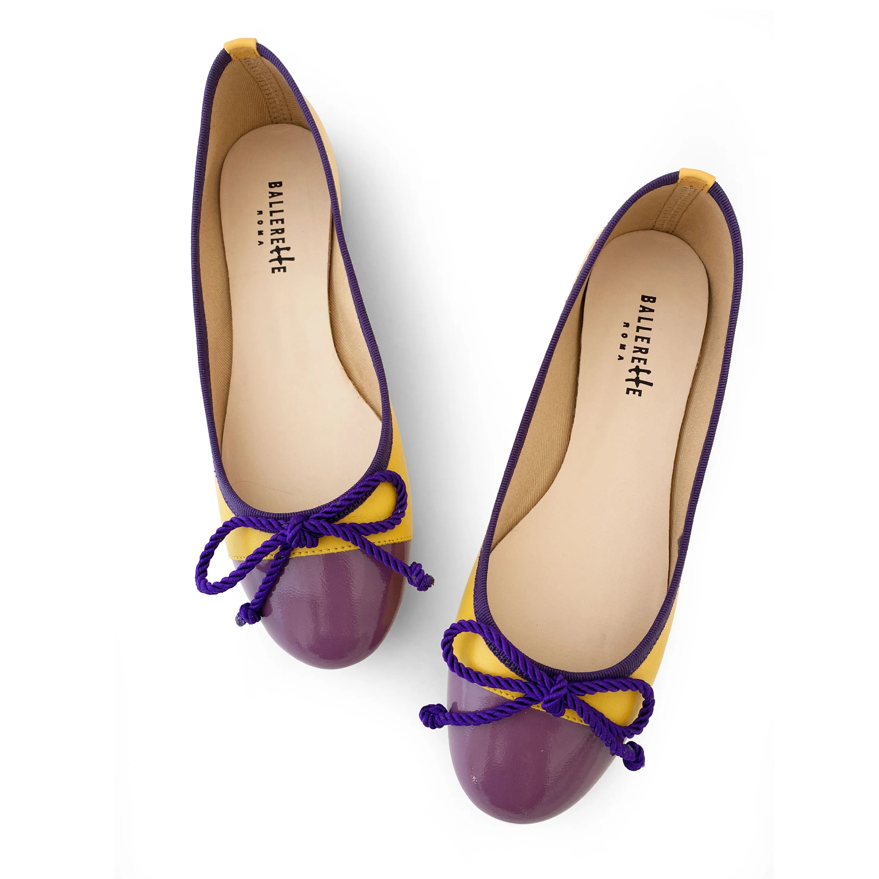 Yellow leather ballet flats with purple toe and bow