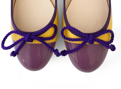 Yellow leather ballet flats with purple toe and bow